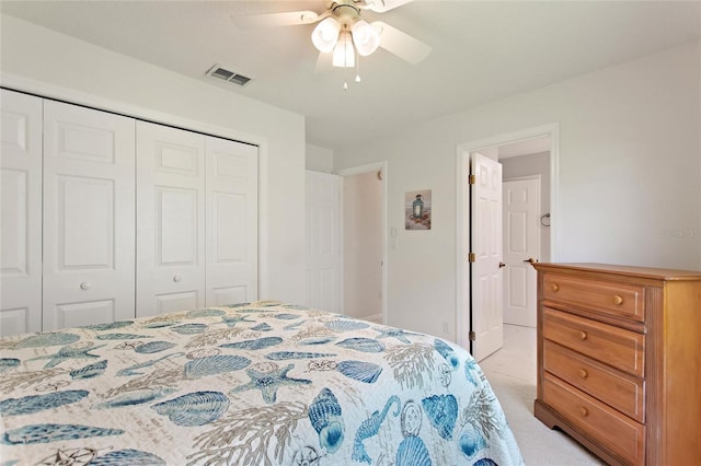 bedroom featuring ceiling fan, a closet, and light carpet