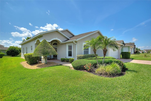 view of front of house featuring a garage and a front yard