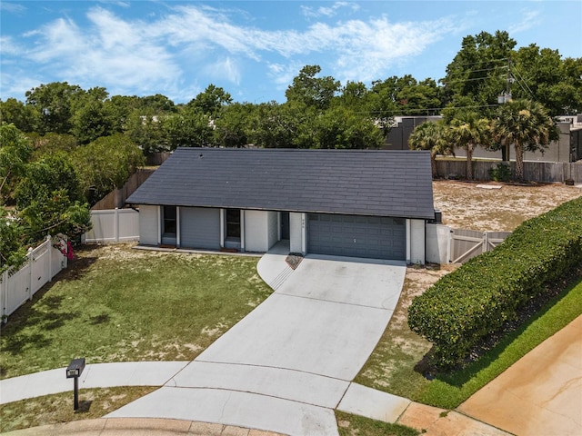 ranch-style home with a front yard and a garage