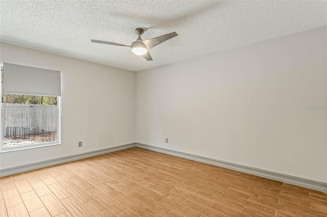 unfurnished room with ceiling fan, a textured ceiling, and light hardwood / wood-style flooring