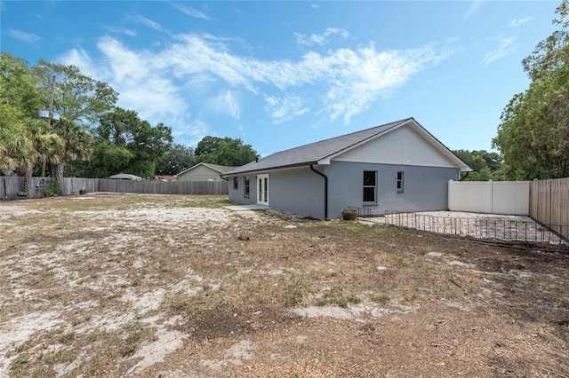 back of house with a patio