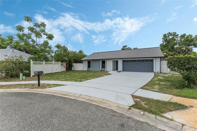 view of front facade featuring a garage and a front lawn