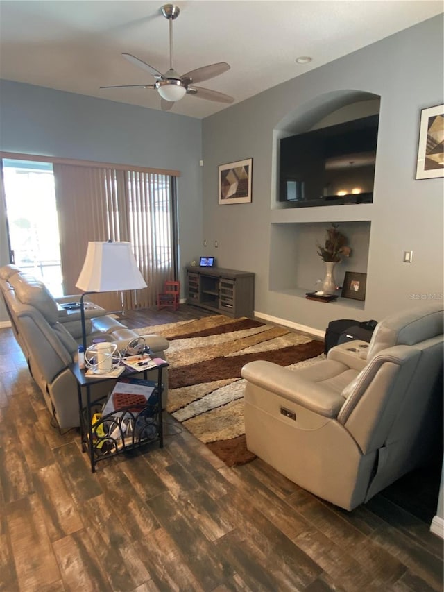 living room with ceiling fan and dark hardwood / wood-style flooring