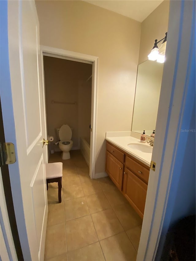 bathroom with tile patterned floors, vanity, and toilet