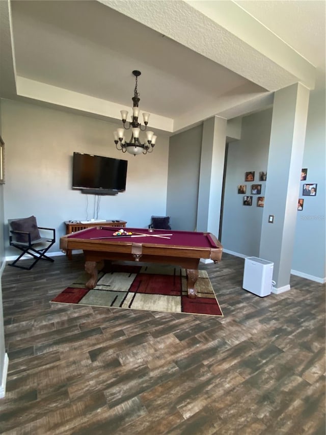 playroom featuring a tray ceiling, dark hardwood / wood-style flooring, an inviting chandelier, and pool table