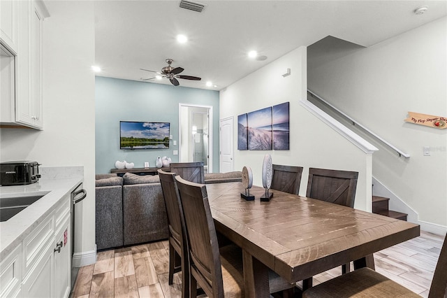 dining room with ceiling fan and sink