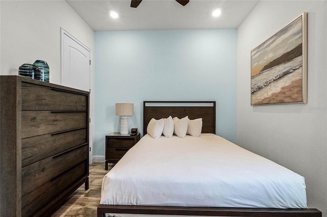 bedroom with ceiling fan and hardwood / wood-style floors