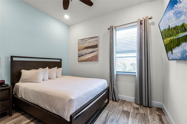 bedroom featuring multiple windows, ceiling fan, and light hardwood / wood-style flooring