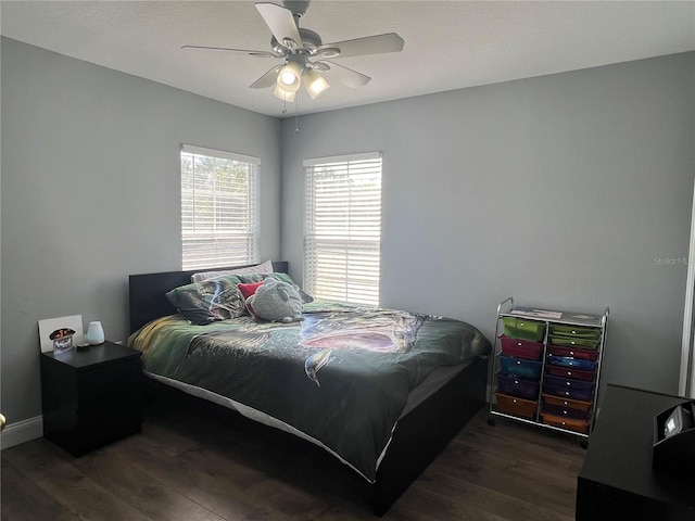 bedroom featuring dark hardwood / wood-style flooring and ceiling fan