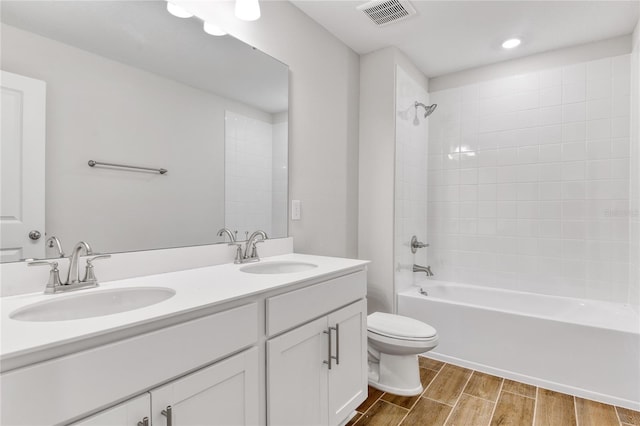 full bathroom with vanity, shower / bathtub combination, and toilet