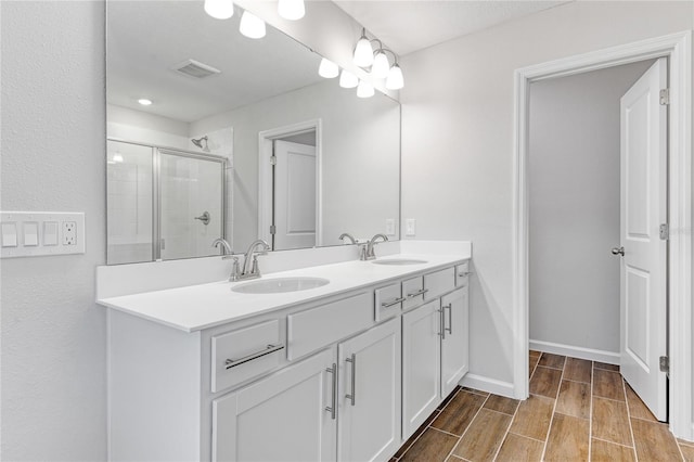 bathroom featuring vanity and a shower with shower door