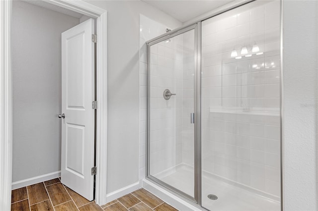 bathroom featuring a shower with door