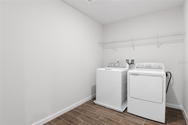 clothes washing area featuring washer and clothes dryer