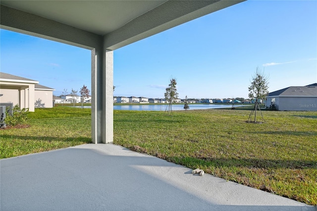 view of yard featuring a patio area and a water view