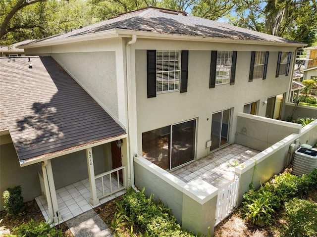 rear view of house with a patio and central AC unit