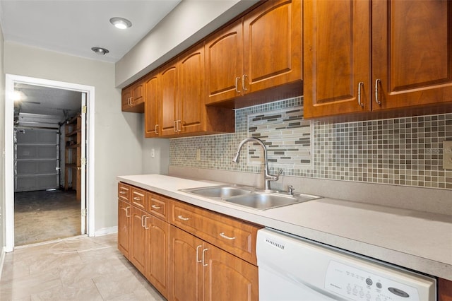 kitchen featuring light tile patterned flooring, backsplash, white dishwasher, and sink