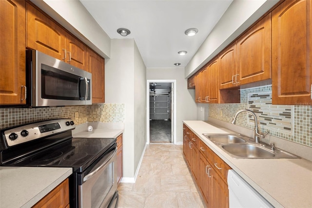 kitchen featuring decorative backsplash, appliances with stainless steel finishes, and sink