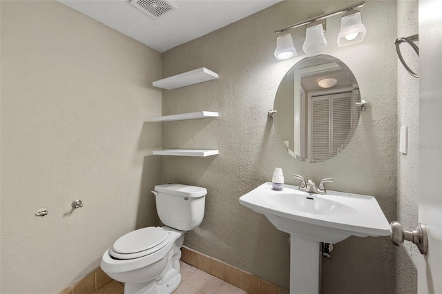 bathroom featuring tile patterned floors and toilet