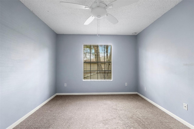 carpeted empty room featuring ceiling fan and a textured ceiling