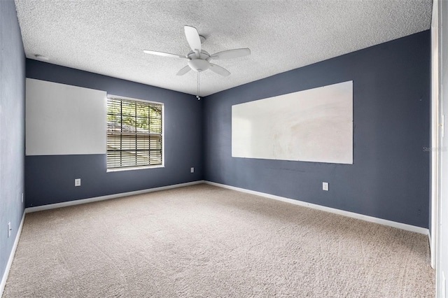 carpeted empty room with ceiling fan and a textured ceiling