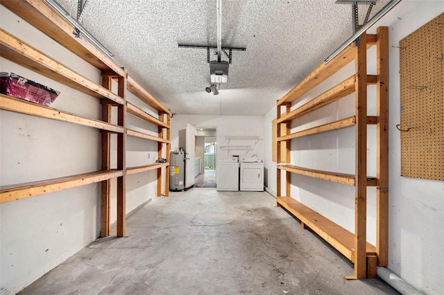 storage area featuring electric water heater and washing machine and clothes dryer