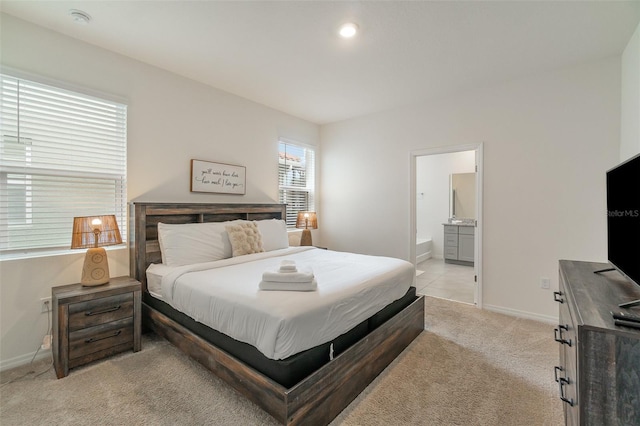 carpeted bedroom featuring ensuite bath