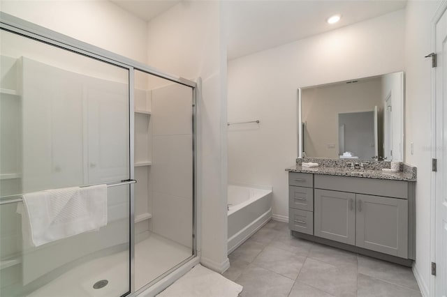 bathroom with tile patterned flooring, shower with separate bathtub, and vanity