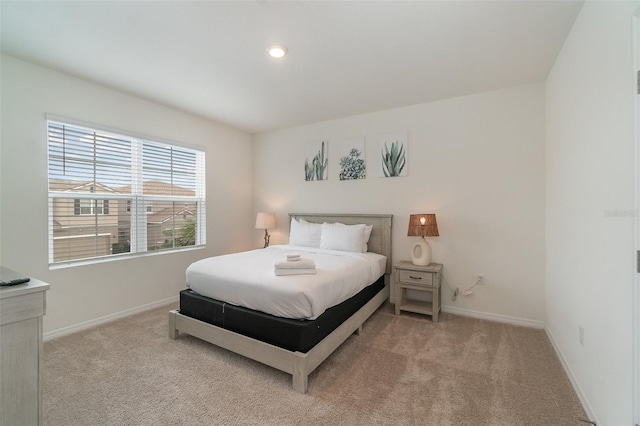 bedroom featuring light carpet