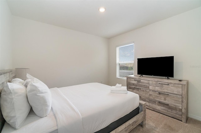 bedroom featuring light colored carpet