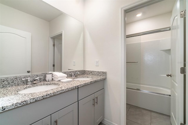 bathroom with tile patterned flooring, vanity, and combined bath / shower with glass door