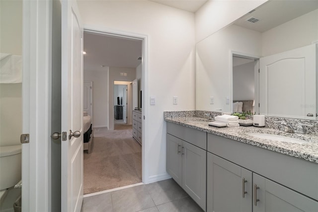 bathroom featuring tile patterned floors, vanity, and toilet