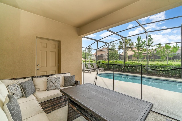 view of swimming pool with an outdoor living space, a patio, and a lanai