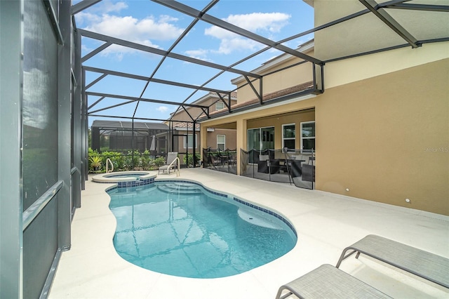 view of pool featuring an in ground hot tub, a patio, and a lanai