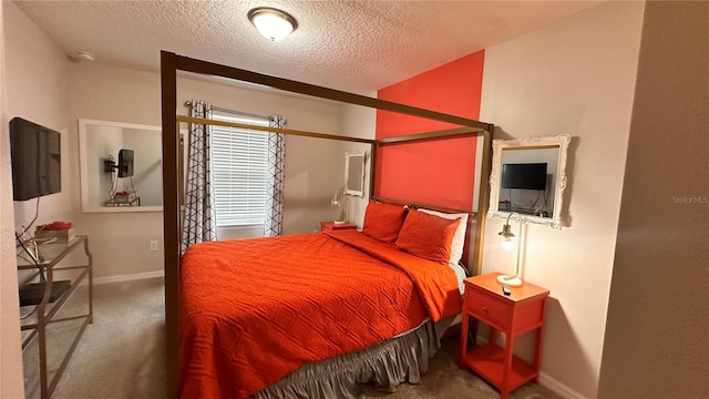 bedroom featuring a textured ceiling and carpet flooring