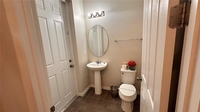 bathroom with tile patterned floors, toilet, and sink