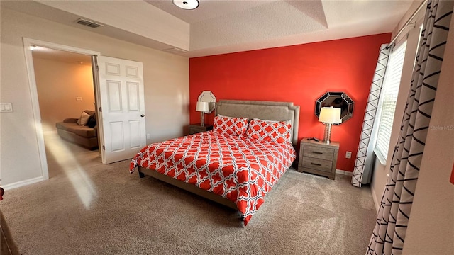 bedroom featuring carpet flooring and a textured ceiling