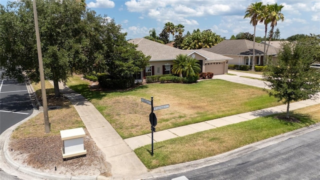 view of front of house featuring a garage and a front lawn