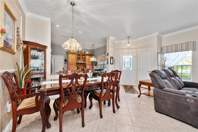 dining space featuring light tile patterned floors and ornamental molding