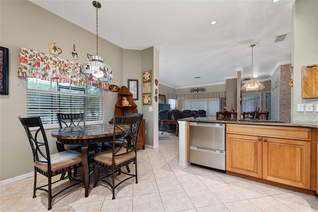 dining area featuring crown molding, sink, and light tile patterned floors