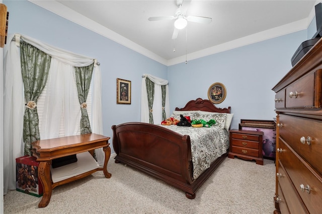 carpeted bedroom featuring ceiling fan and ornamental molding