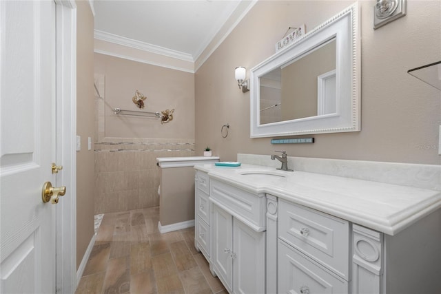 bathroom with vanity, crown molding, and tile walls