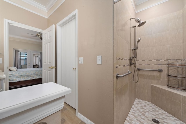 bathroom with ceiling fan, a tile shower, crown molding, and french doors