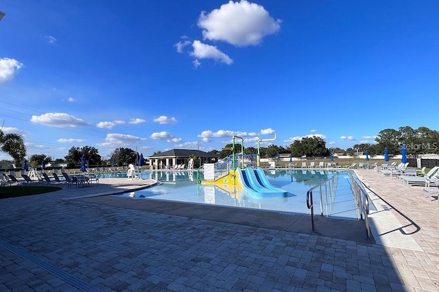 view of pool featuring a playground