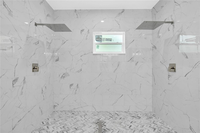 interior details featuring tiled shower