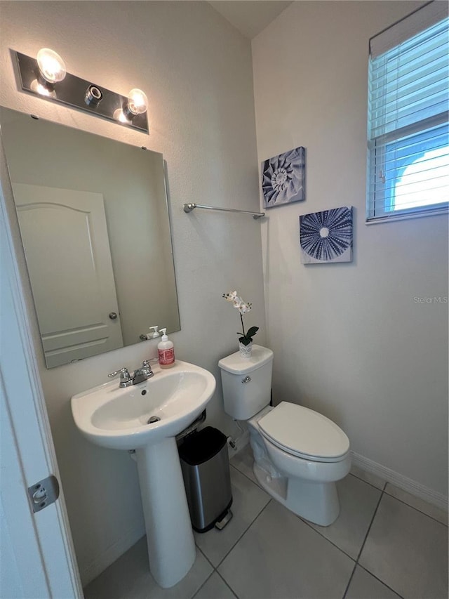 bathroom with tile patterned flooring and toilet