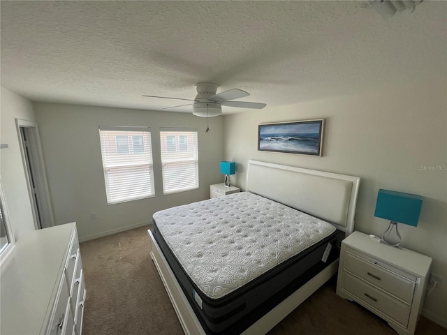 carpeted bedroom with ceiling fan and a textured ceiling