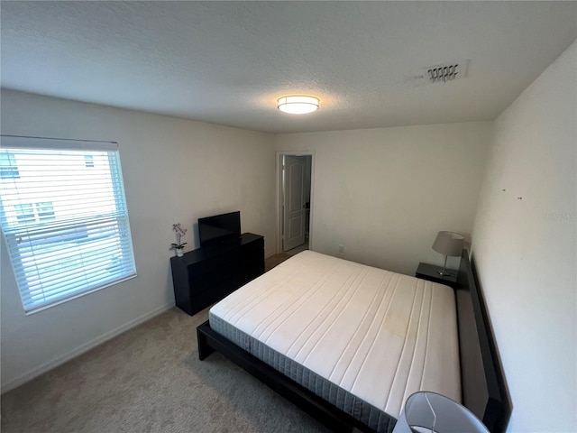 carpeted bedroom with a textured ceiling