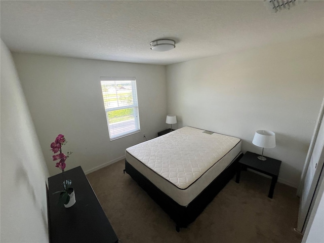 carpeted bedroom with a textured ceiling