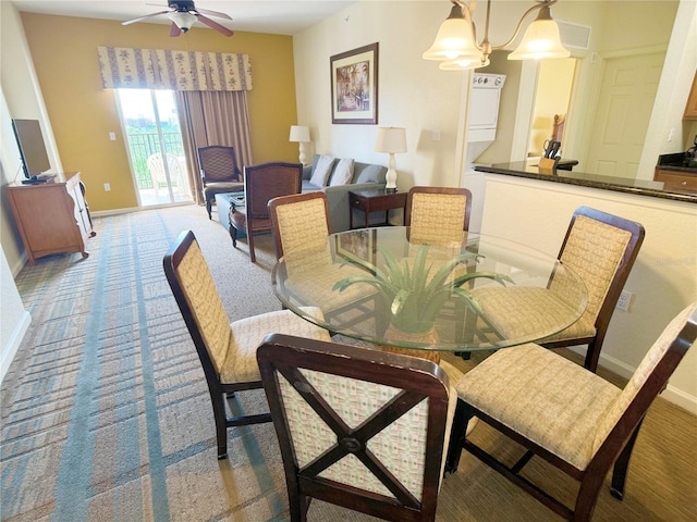 carpeted dining room with ceiling fan