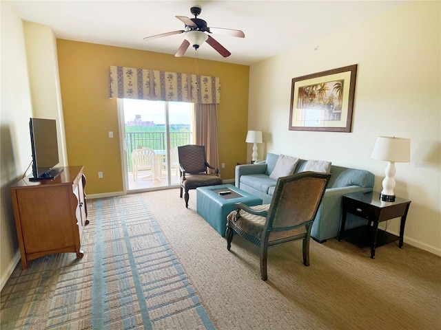 carpeted living room featuring ceiling fan